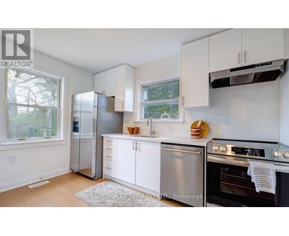 A kitchen with white cabinets and stainless steel appliances.