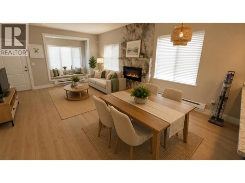 A well-lit, spacious living room with a dining area and a fireplace.
