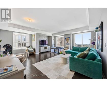 A living room with a green couch and a white coffee table.