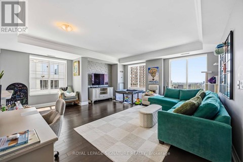 A living room with a green couch and a white coffee table.