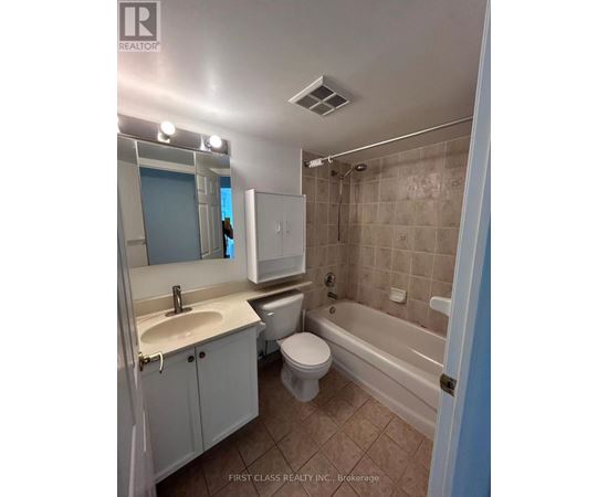 A bathroom with a toilet, sink, and bathtub.