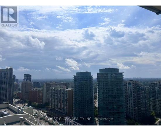 A cityscape with apartment buildings and a clear sky.