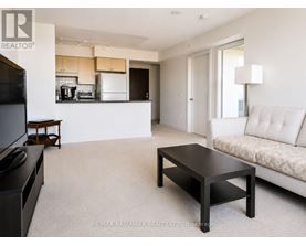 A living room with a white couch and a coffee table.