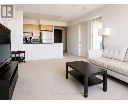A living room with a white couch and a coffee table.