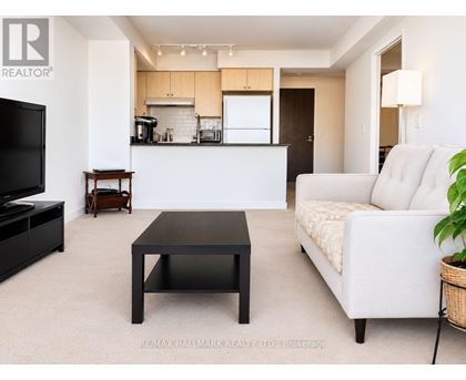 A living room with a white couch and a black coffee table.