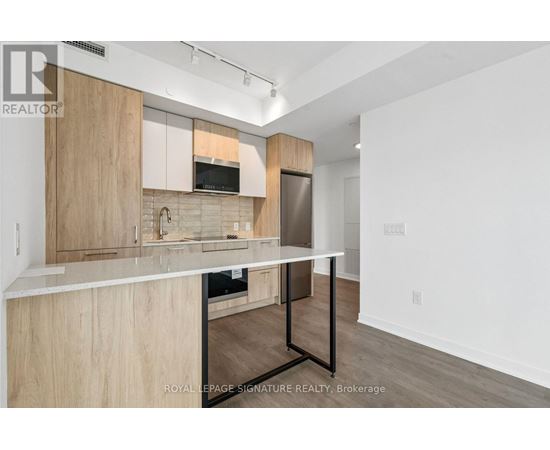 A kitchen with wooden cabinets and a white countertop.
