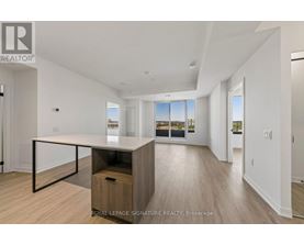 A spacious room with a desk and a window overlooking a cityscape.