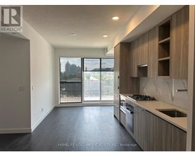 A spacious kitchen with a view of the city.