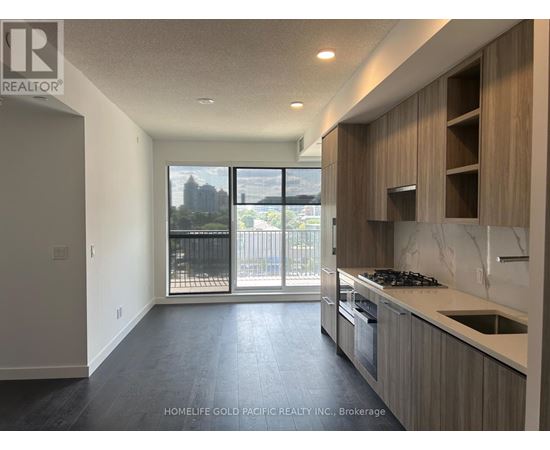 A spacious kitchen with a view of the city.
