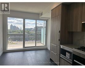 A kitchen with a view of the city skyline.