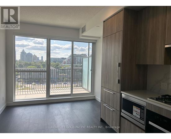 A kitchen with a view of the city skyline.