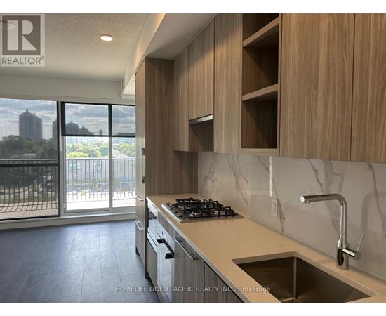 A modern kitchen with wooden cabinets and a marble backsplash.