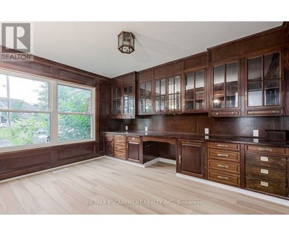 A large kitchen with wooden cabinets and drawers.