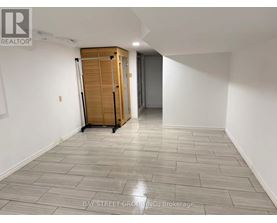 A room with a wooden cabinet and a grey floor.