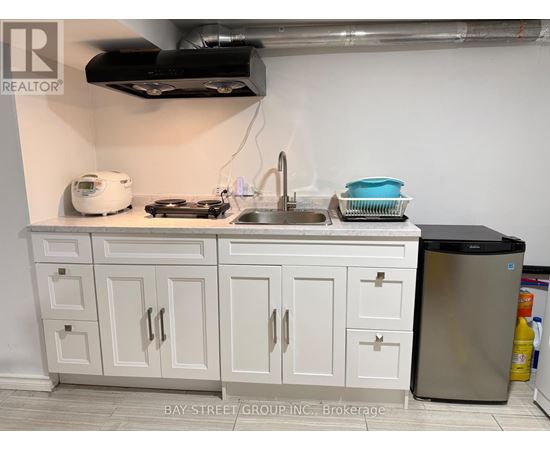 A kitchen with white cabinets and a stainless steel dishwasher.