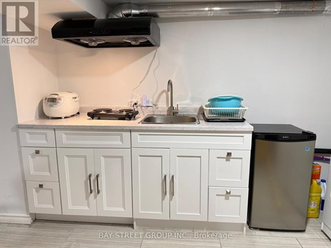 A kitchen with white cabinets and a stainless steel dishwasher.