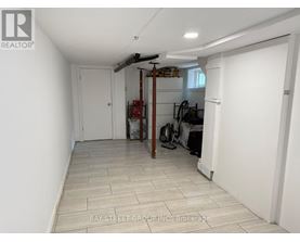 A room with a white door and a white wall with a logo on it.