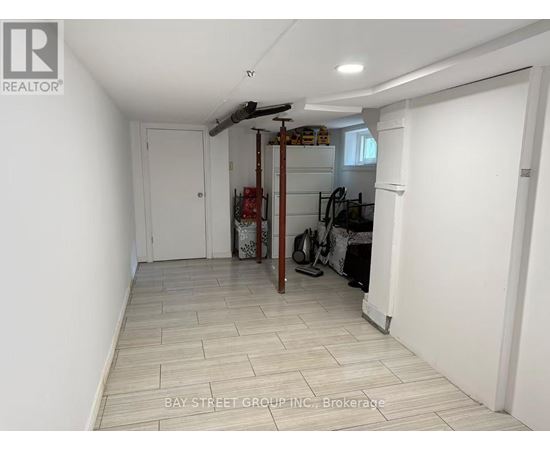 A room with a white door and a white wall with a logo on it.