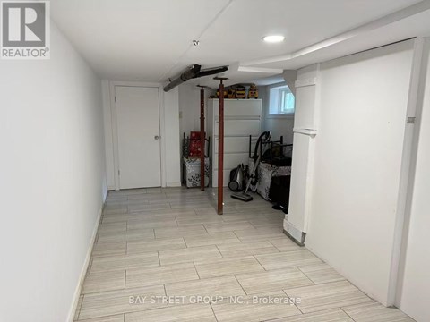 A room with a white door and a white wall with a logo on it.