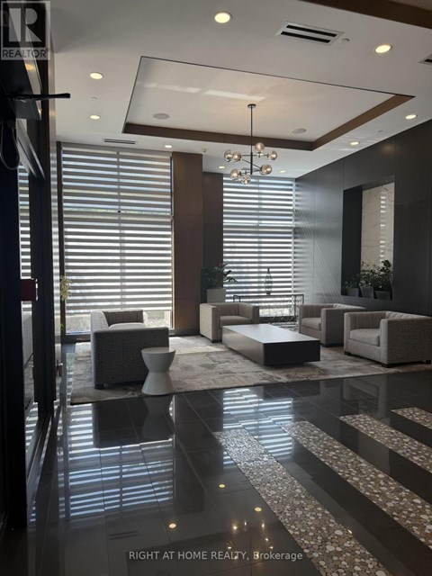 A modern living room with a glass floor and a chandelier.