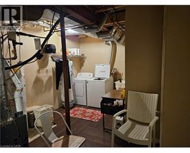 A room with a chair, a table, and a washing machine.