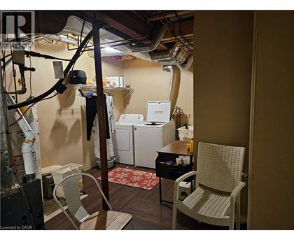 A room with a chair, a table, and a washing machine.