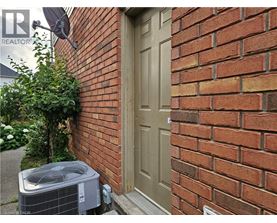 A brown door is on a brick wall.
