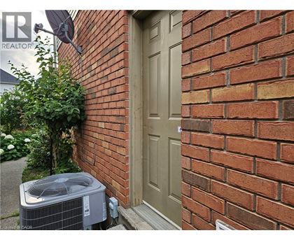 A brown door is on a brick wall.