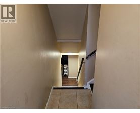 A hallway with a light on and a white vehicle in the background.
