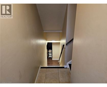 A hallway with a light on and a white vehicle in the background.