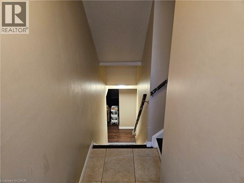 A hallway with a light on and a white vehicle in the background.