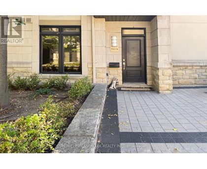 A building with a black door and a sign that says REALTOR.