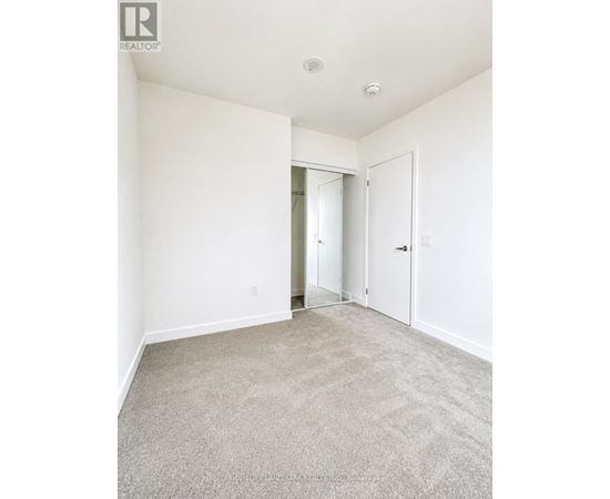A room with a carpeted floor and white walls.