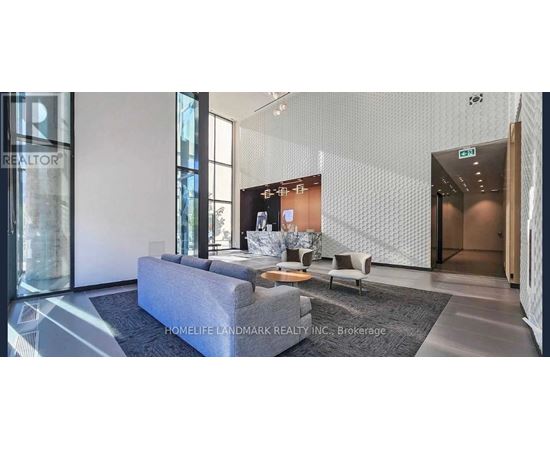 A modern living room with a grey sofa and a coffee table.