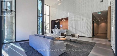 A modern living room with a grey sofa and a coffee table.