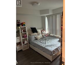 A bedroom with a bed, nightstand, and shelves.