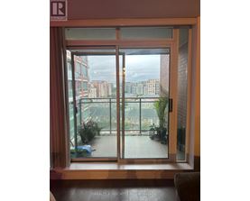 A view of a cityscape through a sliding glass door.