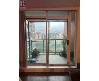 A view of a cityscape through a sliding glass door.