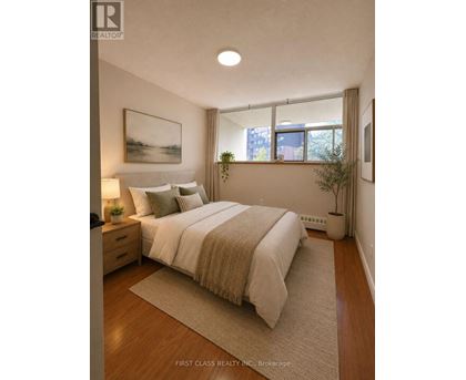 A bedroom with a large bed and a window with a view of the outside.