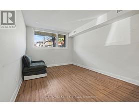 A room with a window and a bench in it.