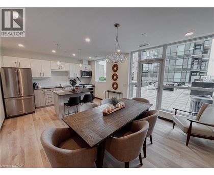 A modern kitchen with a dining table and chairs.