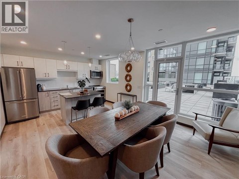 A modern kitchen with a dining table and chairs.