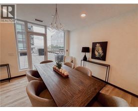 A dining room with a wooden table and chairs.
