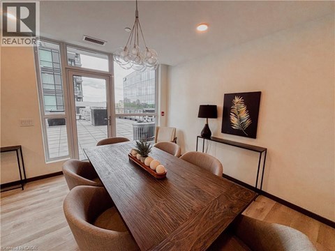 A dining room with a wooden table and chairs.