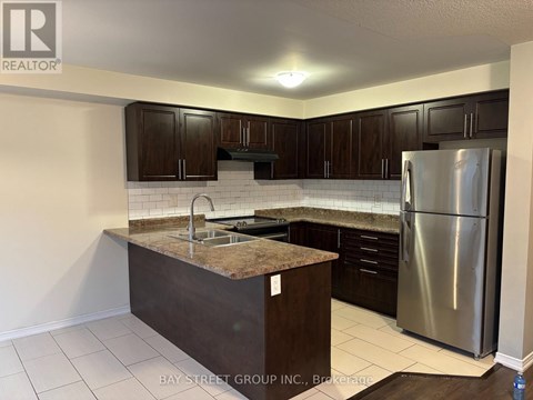 A kitchen with a granite countertop and stainless steel appliances.
