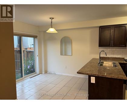 A kitchen with a granite countertop and a sink.