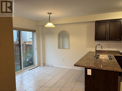 A kitchen with a granite countertop and a sink.