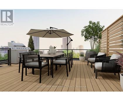 A patio with a table and chairs and a large umbrella.