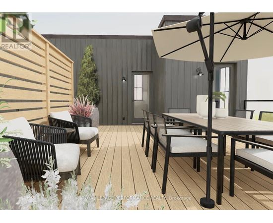 A modern outdoor seating area with a wooden floor and black metal chairs.
