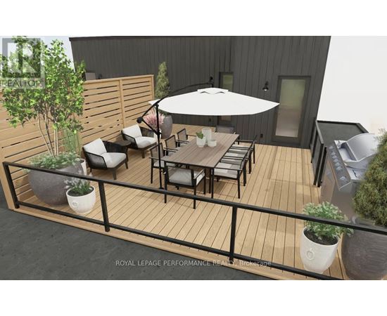 A patio with a table and chairs and a white umbrella.